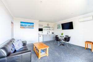 a living room with a couch and a table at Roto View - Beautiful views of Lake Tekapo in Lake Tekapo