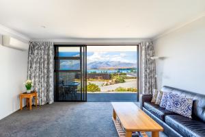 a living room with a couch and a table at Roto View - Beautiful views of Lake Tekapo in Lake Tekapo