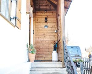 a wooden door on a house with stairs at Naturhaus Luminus in Bad Aibling