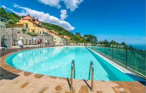 a swimming pool with a view of the ocean at Awesome Home In Magliolo-finale Ligure With 2 Bedrooms And Outdoor Swimming Pool in Magliolo