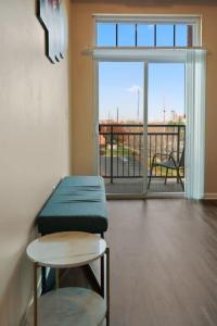 a room with a bench and a view of a balcony at Your Summer Get Away with GYM in Indianapolis