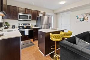 a kitchen and living room with a couch and a counter at Your Cozy One Bedroom Midtown in Detroit