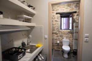 a small bathroom with a sink and a toilet at το σπίτι του δάσκαλου- teacher's house in Sirako