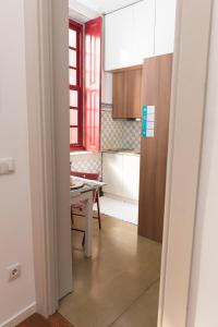 a kitchen with a table and a dining room at Santo da Casa / Sc apartments in Porto