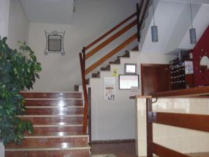 
a hallway that has stairs leading up to a kitchen at Hotel Azahar in Oliva
