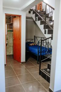 a room with a bunk bed and a staircase at Departamentos KAYLU in El Bolsón