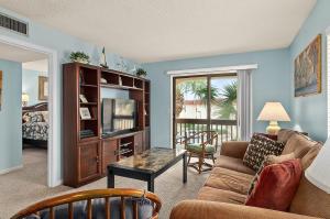 a living room with a couch and a coffee table at Unit 6302 - Ocean & Racquet Resort in Saint Augustine Beach