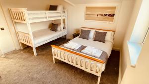 sypialnia z 2 łóżkami piętrowymi i drabiną w obiekcie Luxury Penthouse near Swanage Beach and Town w mieście Swanage
