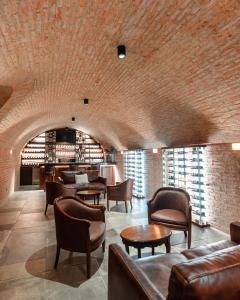 a lobby with leather furniture and a brick wall at Hotel Boutique Los Pasos & Spa in Antigua Guatemala