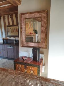 a living room with a mirror and a table at La Venelle Saint Jean in Honfleur