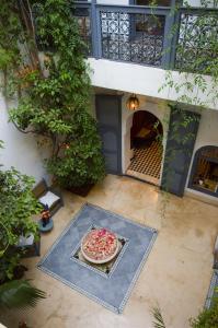 an overhead view of a pizza on a patio at Dar Touyir in Marrakesh