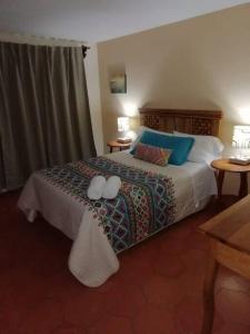 a bedroom with a bed with two pillows on it at Casa Emmanuel in Guanajuato
