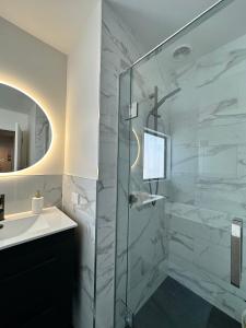 a bathroom with a glass shower and a sink at Gem in Papanui Christchurch in Christchurch