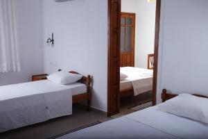 a room with two beds and a mirror at Apollon Hotel in Patara +65 photos