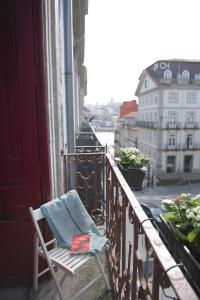 a towel sitting on a chair on a balcony at Santo da Casa / Sc apartments in Porto