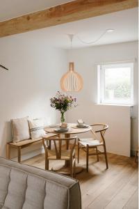 a living room with a table and a couch at Brut the lodges in Reijmerstok