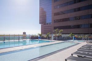 a swimming pool on the roof of a building at Downtown 1BR w Pool Gym WD nr Staples Center LAX-551 in Los Angeles