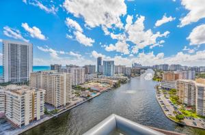 a view of a river in a city with tall buildings at Beachwalk Resort #2301 - MODERN RESORT 3BDR and 3BA - BALCONY, GYM, AMAZING POOL in Hallandale Beach