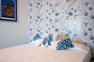 a bedroom with a bed with blue and white wallpaper at Villa Grazia Lipari in Lipari