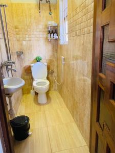 a bathroom with a toilet and a sink at Arches&Palms Residence in Arusha