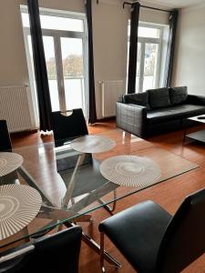 a living room with a glass table and a couch at Spa Moser apartments in Karlovy Vary