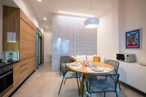 a kitchen and dining room with a table and chairs at Villa Grazia Lipari in Lipari