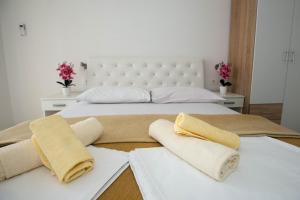 a bedroom with two beds with towels on them at Rooms Ivana in Međugorje