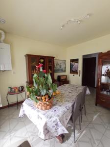 a dining room table with a basket of flowers on it at Casa Doretta - Camere Rooms in Verona