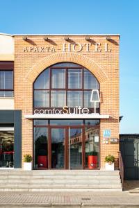 a brick building with a sign for aaria hotel at Apartahotel Comforsuite in Boecillo