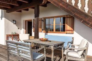 a wooden table and chairs on a patio at Chalet Sophie in Longostagno