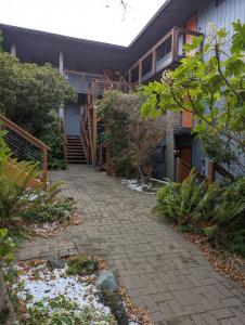a walkway in front of a building with a staircase at The Landmark Inn on Orcas Island in Eastsound