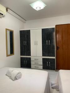 ein Schlafzimmer mit zwei Betten und einer Kommode in der Unterkunft PORTO GALINHAS TODO MOBILIADO 5 minutos a pé da praia in Porto De Galinhas