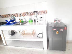a small kitchen with a sink and a refrigerator at apartamento tercer piso cali in Cali