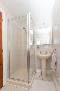 a bathroom with a shower and a sink at Oceanside in Wyke Regis