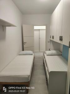 a small room with two beds and a closet at La Casa Di Lilla in Tortoreto Lido