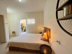 a bedroom with a bed and a mirror on the wall at Eilat charming & cozy Studio in Eilat