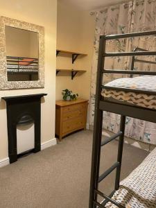 a bedroom with a bunk bed and a mirror at Gloucester Rd 2 mins away - Fab, new, trendy house in Bristol