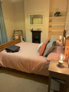 a bedroom with a bed and a table and a mirror at Gloucester Rd 2 mins away - Fab, new, trendy house in Bristol