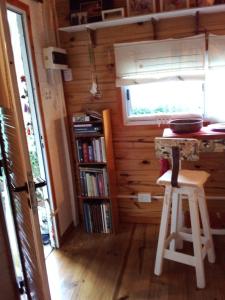 a kitchen with a table and a stool in a room at Cabaña La Paz in Tigre +145 photos