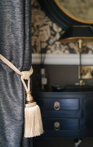a curtain with a tassel attached to a dresser at 40Winks in Durham