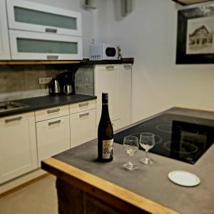 a bottle of wine sitting on a counter with two wine glasses at Ferienhaus Drakenhof in Bad Salzuflen