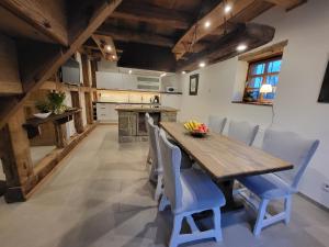 a kitchen with a wooden table and blue chairs at Ferienhaus Drakenhof in Bad Salzuflen +24 photos