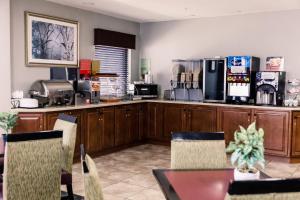 a kitchen with a table and a counter with a refrigerator at Carpenter Street Hotel in Springfield