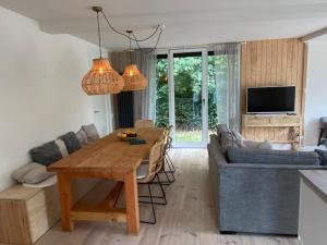 a living room with a table and a couch at De Keizerskroon 240 in Julianadorp