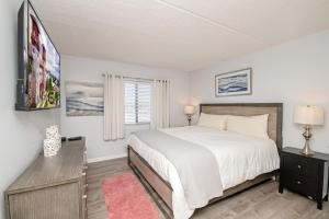 a bedroom with a large bed and a window at 4205 Courtyard Villa 2nd Fl N in Saint Augustine Beach