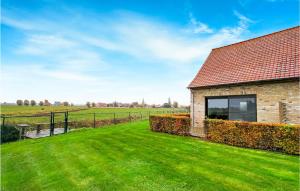 a house with a green lawn next to a building at Awesome Home In Diksmuide With Wifi in Diksmuide