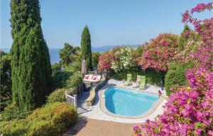 a swimming pool in a garden with trees and flowers at Nice Home In Rayol-canadel-sur-mer With 2 Bedrooms, Wifi And Outdoor Swimming Pool in Rayol-Canadel-sur-Mer