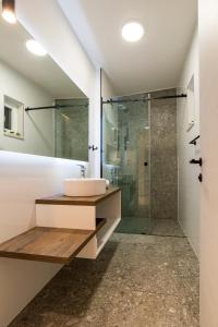 a bathroom with a sink and a shower at Apartments & Rooms Grašo in Split