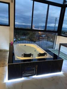 a bath tub in a building with a large window at Heinz B. in Santa Ana de los Caballeros