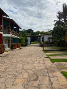 a stone driveway in front of a building at Vivendas do Serrano Apart105 Lençois in Lençóis